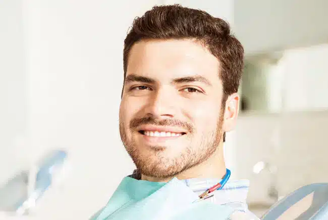 male patient smiling after dental bridge treatment in Allen